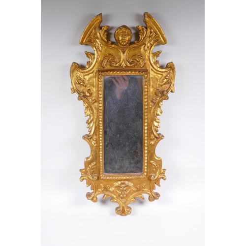 1046 - An Italian gilt wall mirror decorated with swags and masks, 28 x 65cm, losses