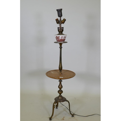 1053 - A bronze tiered floor lamp with a wooden table and tripod supports, 126cm high