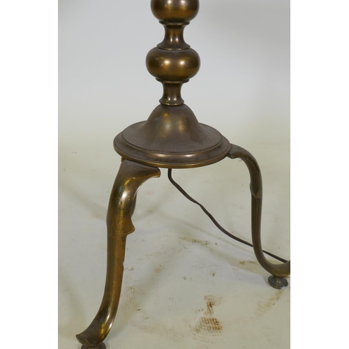 1053 - A bronze tiered floor lamp with a wooden table and tripod supports, 126cm high