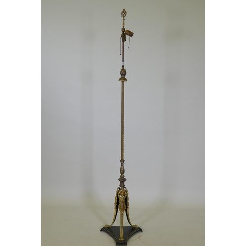 1054 - An antique bronze and ormolu standard lamp with Empire style decoration and triform base, 168cm high