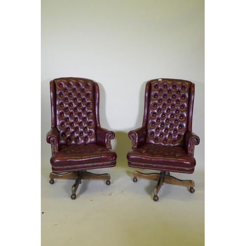 1056 - A pair of button back swivel office chairs with high backs, AF frayed