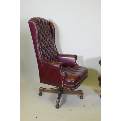 1056 - A pair of button back swivel office chairs with high backs, AF frayed