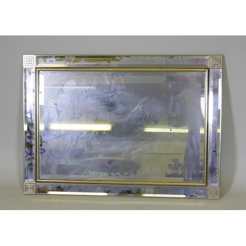 1068 - A contemporary wall sectioned wall mirror with bevelled glass and gilt frame, 90 x 65cm