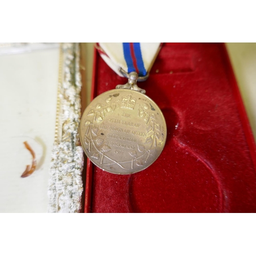 107 - An Elizabeth II Silver Jubilee medal with ribbon in original case, with citation