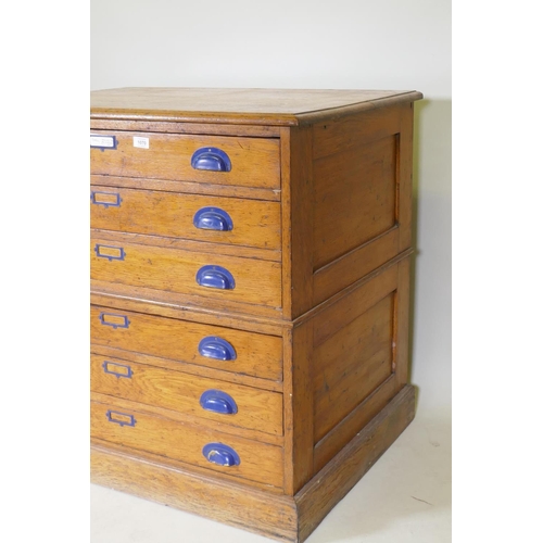 1070 - An early C20th golden oak plan chest in two sections of three drawers, 95 x 69cm, 89cm high