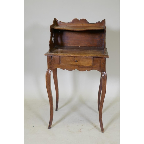 1075 - An early C19th French fruitwood single drawer side table with shaped gallery and pierced sides, rais... 