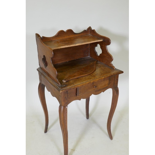 1075 - An early C19th French fruitwood single drawer side table with shaped gallery and pierced sides, rais... 