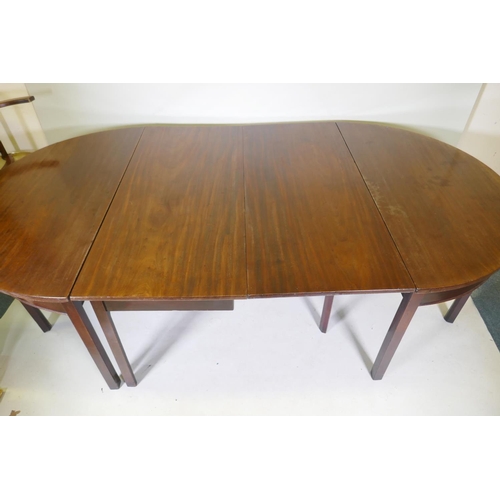 1079 - A Georgian mahogany dining table in three sections, two demi lune end sections and a centre section ... 