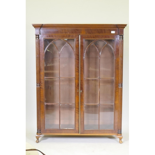 1081 - A Regency mahogany bookcase top with reeded columns flanking two gothic astragal glazed doors, raise... 