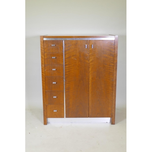 1090 - A mid century Founders walnut and metal gentleman's wardrobe, comprising a flight of six drawers and... 