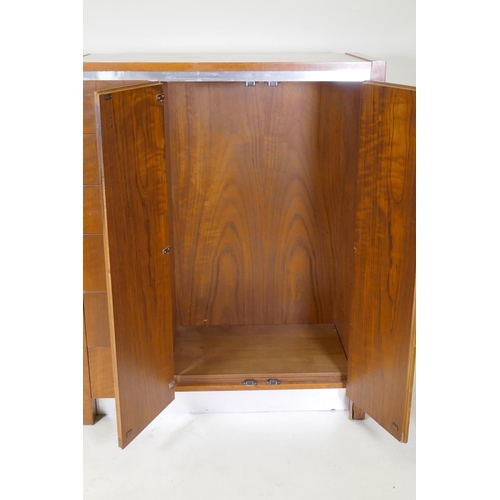 1090 - A mid century Founders walnut and metal gentleman's wardrobe, comprising a flight of six drawers and... 