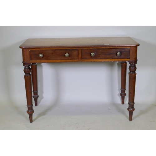 1102 - An early C19th mahogany writing table with two drawers, raised on tapering turned supports, 107 x 52... 