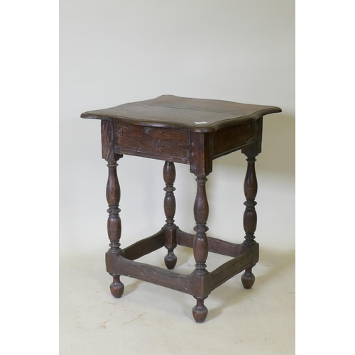 1107 - A late C17th/early C18th oak side table with shaped top and pegged construction, raised on baluster ... 