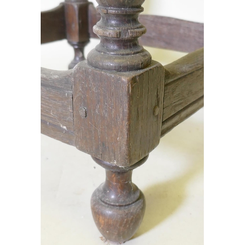 1107 - A late C17th/early C18th oak side table with shaped top and pegged construction, raised on baluster ... 