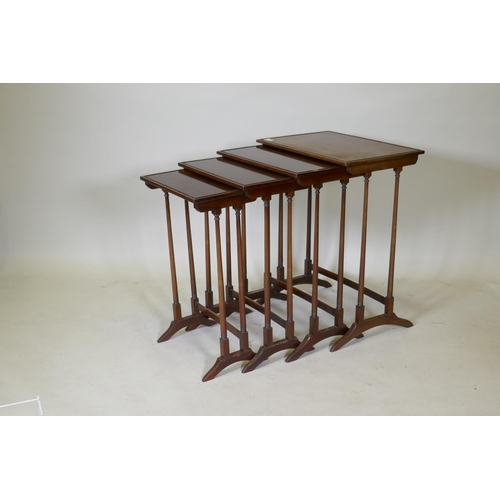 1108 - A quartetto nest of mahogany occasional tables, with beaded tops, raised on slender turned tapering ... 