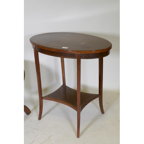 1109 - A Victorian mahogany two tier occasional table with oval top, raised on sabre supports, 70 x 43 x 70... 