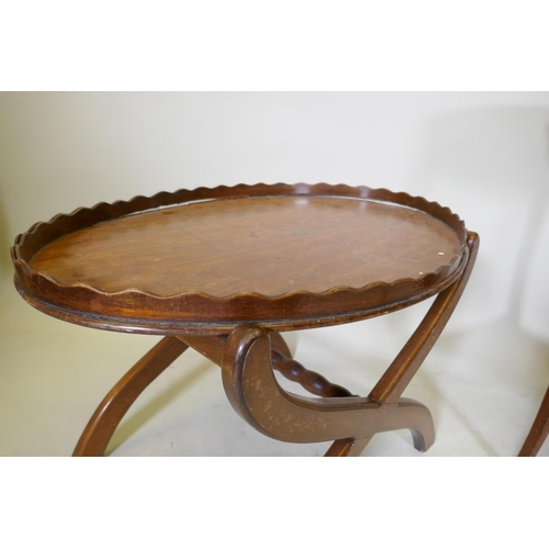 1109 - A Victorian mahogany two tier occasional table with oval top, raised on sabre supports, 70 x 43 x 70... 