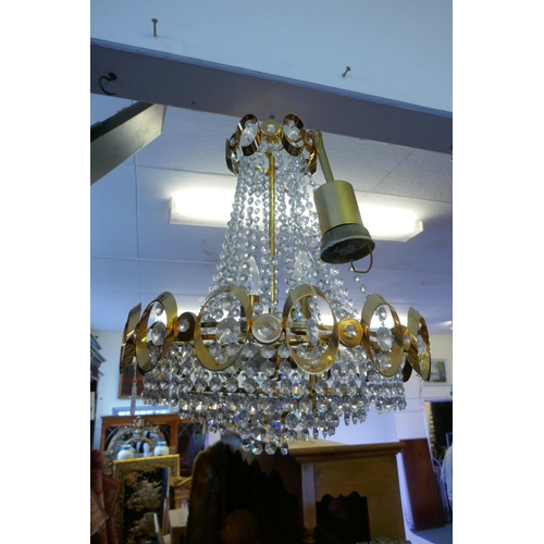 1114 - A 1960s gilt metal Empire inspired chandelier with glass drops, 50cm drop excluding chain