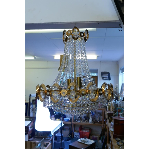 1114 - A 1960s gilt metal Empire inspired chandelier with glass drops, 50cm drop excluding chain