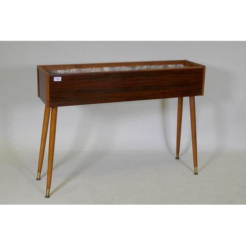 1126 - A mid-century planter with rosewood design, formica sides, pine lined with a metal liner, raised on ... 