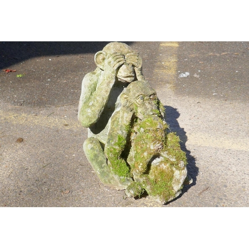 1131 - Three concrete garden monkeys 'hear no, speak no, see no evil', largest 31cm high