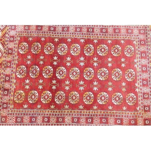 1136 - A vintage Persian rug with geometric designs on a red field, 94 x 150cm