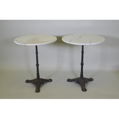 1140 - A pair of marble top bistro tables with cast iron bases, 73cm high x 61cm diameter