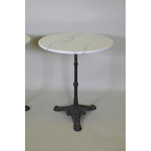 1140 - A pair of marble top bistro tables with cast iron bases, 73cm high x 61cm diameter