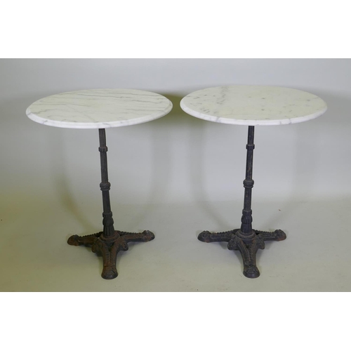 1141 - A pair of marble top bistro tables with cast iron bases, 73cm high x 61cm diameter