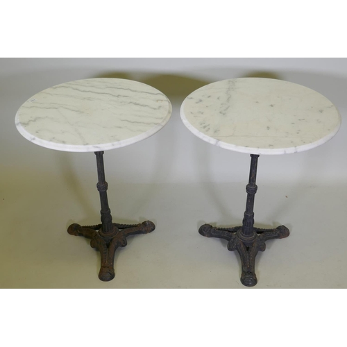 1141 - A pair of marble top bistro tables with cast iron bases, 73cm high x 61cm diameter