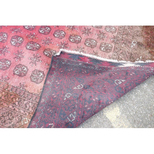 1144 - A hand woven wool Bokhara carpet, faded one end, 200 x 300cm