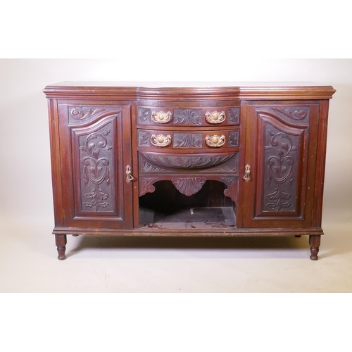 1159 - A Victorian walnut sideboard with carved decoration, two cupboards flanking two bow fronted drawers,... 