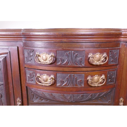 1159 - A Victorian walnut sideboard with carved decoration, two cupboards flanking two bow fronted drawers,... 