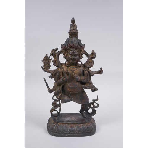 116 - A Tibetan bronze of a wrathful deity with the remnants of gilt patina, impressed double vajra mark t... 