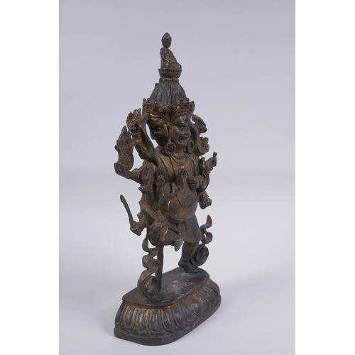 116 - A Tibetan bronze of a wrathful deity with the remnants of gilt patina, impressed double vajra mark t... 