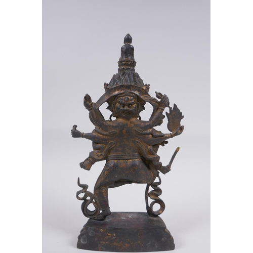 116 - A Tibetan bronze of a wrathful deity with the remnants of gilt patina, impressed double vajra mark t... 