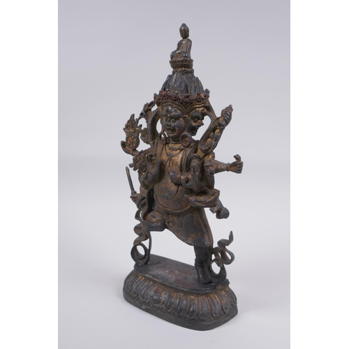 116 - A Tibetan bronze of a wrathful deity with the remnants of gilt patina, impressed double vajra mark t... 