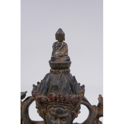 116 - A Tibetan bronze of a wrathful deity with the remnants of gilt patina, impressed double vajra mark t... 