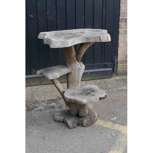 1181 - A root-wood two tier garden table, 85cm high