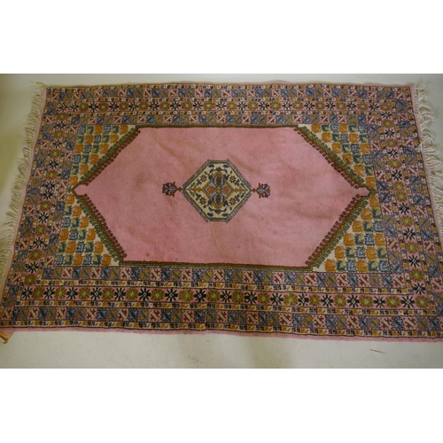 1184 - A pink ground Moroccan wool carpet, 125 x 193cm and a blue ground similar, 123 x 167cm