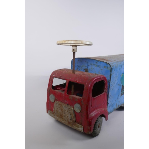 12 - A vintage Triang toys tinplate 'long distance transport' lorry with a sit and steer option, 60cm lon... 