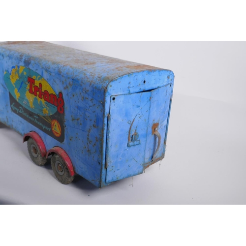 12 - A vintage Triang toys tinplate 'long distance transport' lorry with a sit and steer option, 60cm lon... 