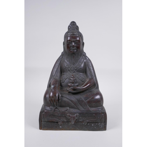 126 - A Sino Tibetan bronze figure of a bearded deity seated in meditation, 29cm high