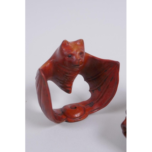 128 - Two Japanese carved boxwood netsuke in the form of a snake and a bat, signed, 5cm long