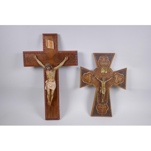 129 - A pokerwork crucifix with brass Christ, and another with a painted composition Christ, largest 28cm ... 