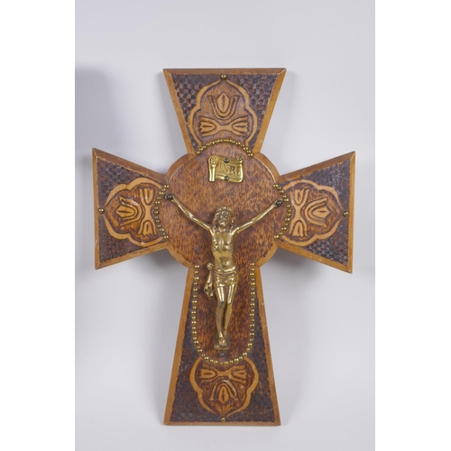 129 - A pokerwork crucifix with brass Christ, and another with a painted composition Christ, largest 28cm ... 