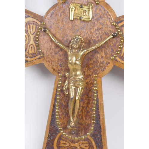 129 - A pokerwork crucifix with brass Christ, and another with a painted composition Christ, largest 28cm ... 