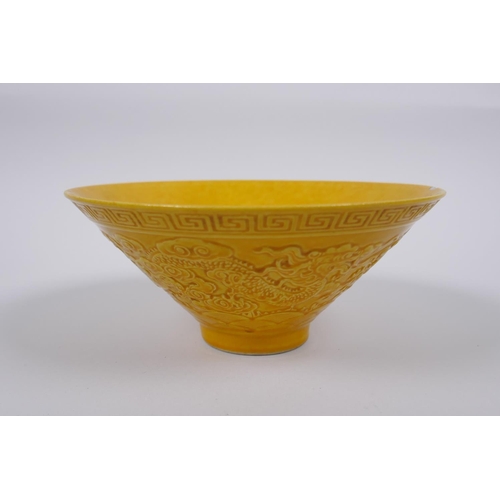 131 - A Chinese yellow ground porcelain bowl of conical form with raised twin dragon decoration, impressed... 