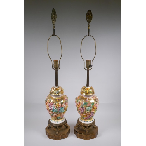 139 - A pair of Capo di Monte jar and covers with raised neoclassical figural decoration, converted to lam... 