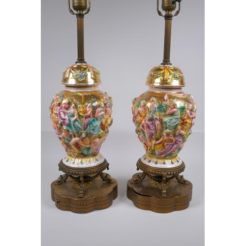 139 - A pair of Capo di Monte jar and covers with raised neoclassical figural decoration, converted to lam... 